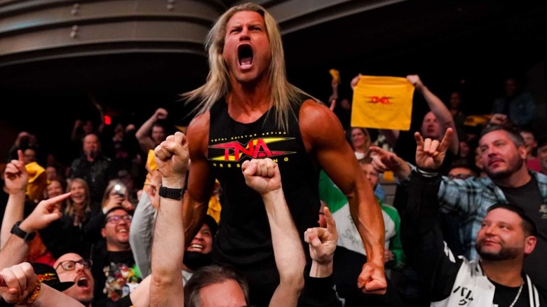 Nic Nemeth screams in the crowd at TNA Hard To Kill in a TNA logo t-shirt.