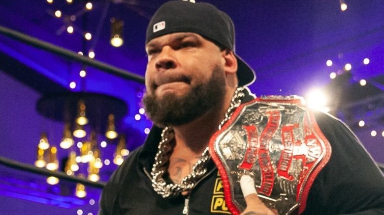 Tyrus carrying a championship belt