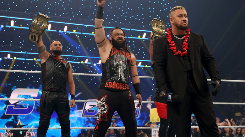 Solo Sikoa, Jacon Fatu, and Tama Tonga standing in a wrestling ring