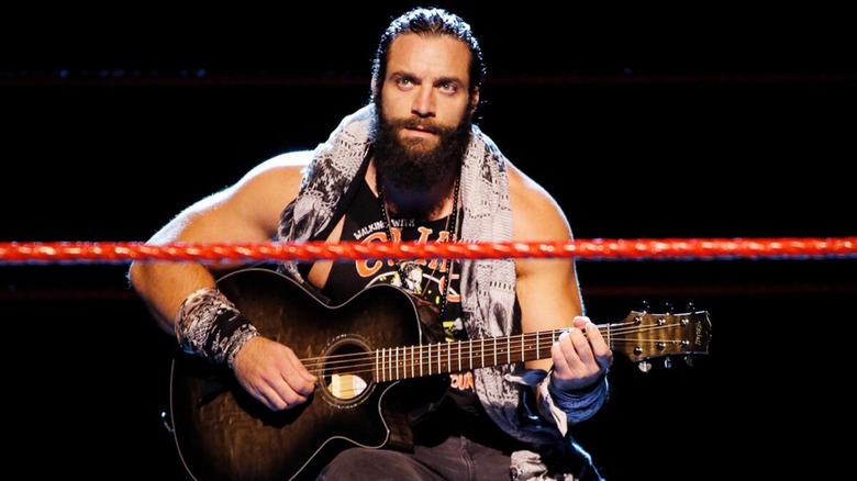 Elijah playing his guitar during an in ring segment whilst still signed to WWE