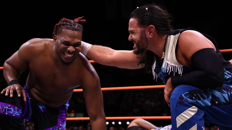 Matt Jackson grips the back of Marq Quen's head