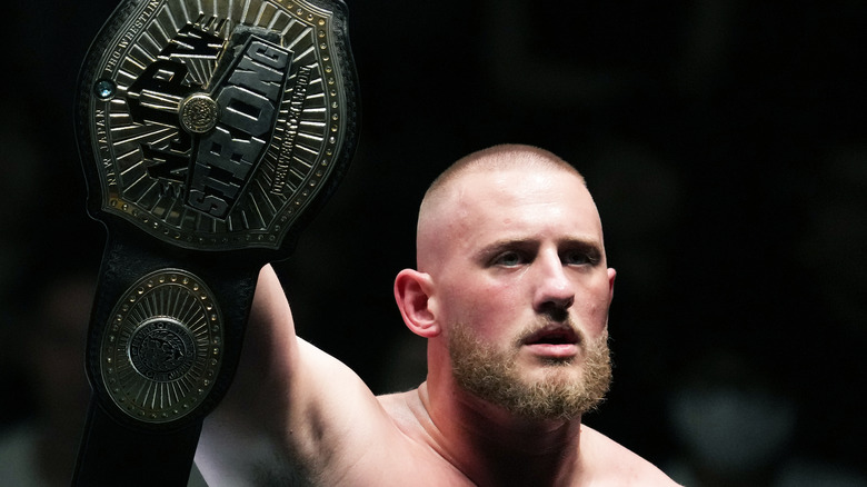 Gabe Kidd holds his NJPW STRONG Openweight Championship high