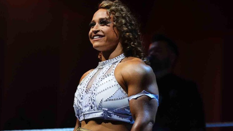 Jordynne Grace stands smiling in the ring before a match against Roxanne Perez during a 