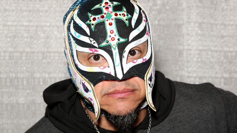 WWE's Rey Mysterio looks at the camera wearing his iconic luchador mask.