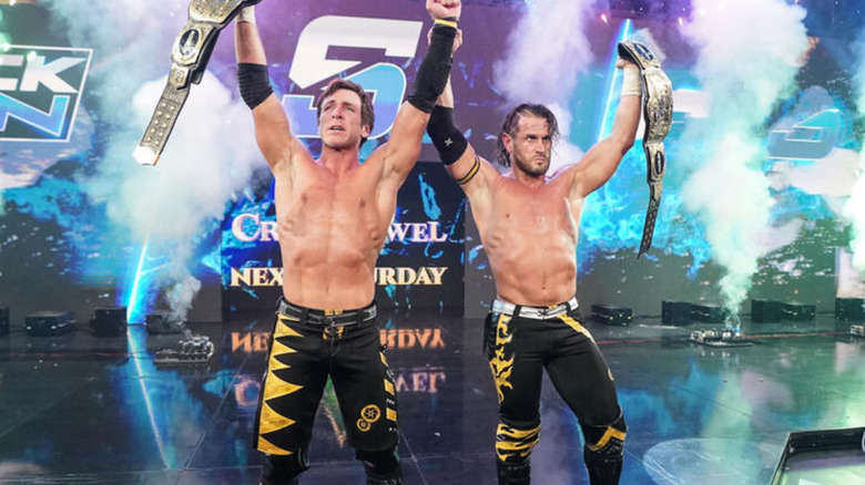 Alex Shelly and Chris Sabin raising their arms with the WWE Tag Team Championship