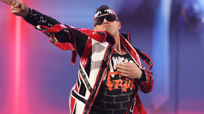 The Miz wearing red ring gear and pointing to the crowd.