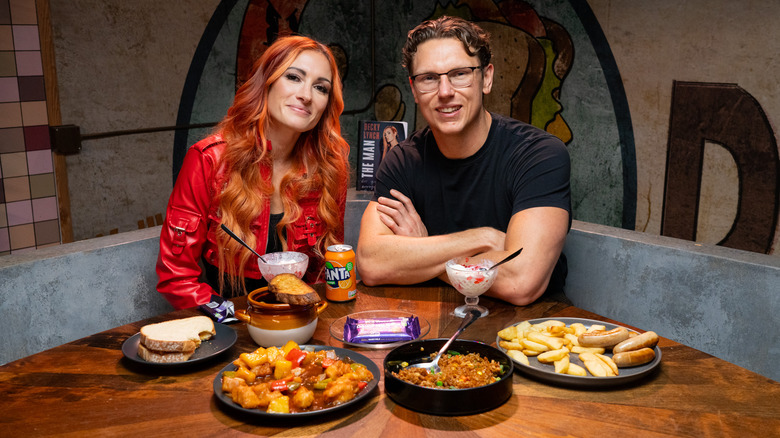 Becky Lynch sitting at dining table on the set of Last Meals