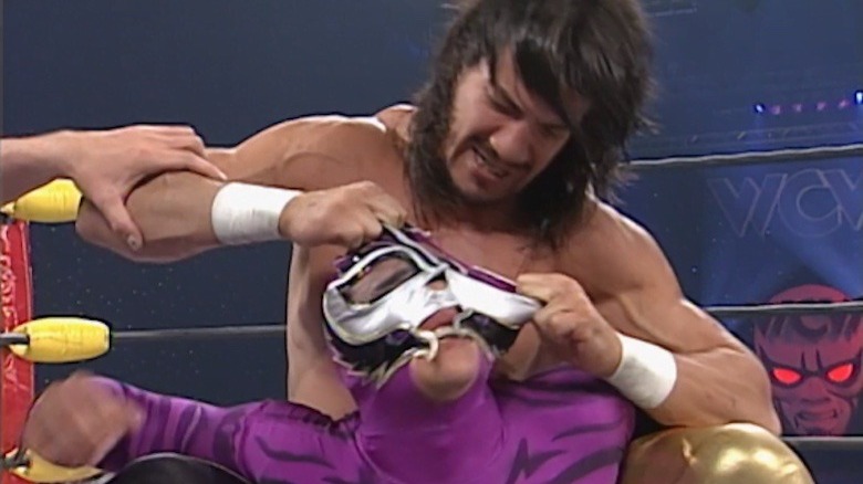 Eddie Guerrero tears at Rey Mysterio's mask at WCW Halloween Havoc 1997