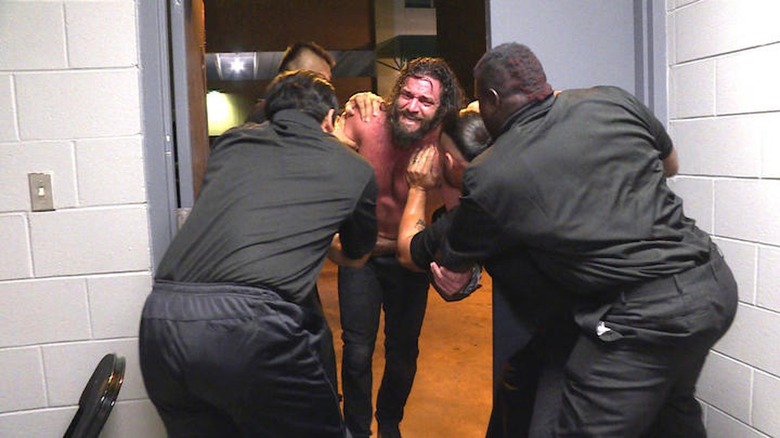 Elias is escorted from the building