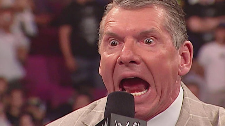 Vince McMahon holds back a sneeze