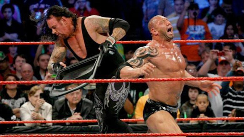 Undertaker hammers Batista with a chair