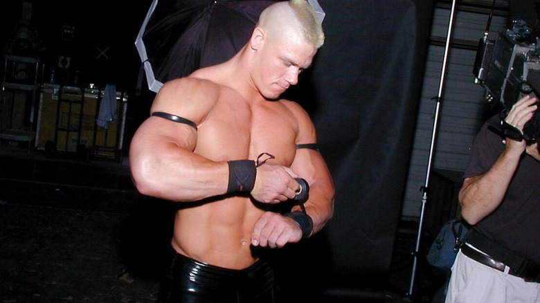 John Cena, his hair cut in a mohawk in his 'Prototype' gimmick, tapes his wrists backstage before a match in Ohio Valley Wrestling.