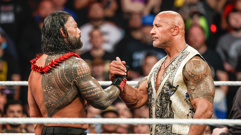 Roman Reigns and Dwayne "The Rock" Johnson embrace during RAW at Intuit Dome on January 6, 2025 in Inglewood, California.