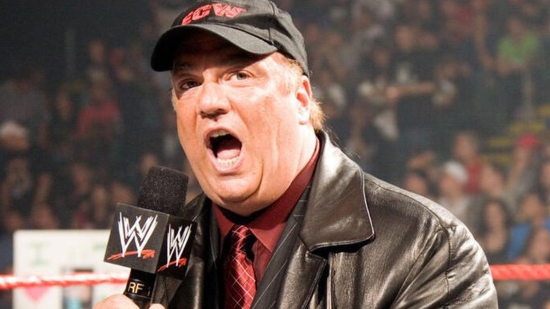 Paul Heyman, wearing an ECW ballcap, cuts a promo into a WWE microphone in the middle of the ring.