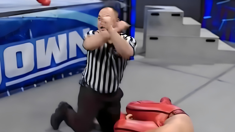 WWE ref makes X symbol