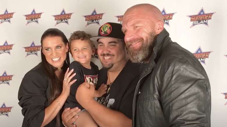 Triple H and Stephanie McMahon pose for photos at Connor's Cure Benefit