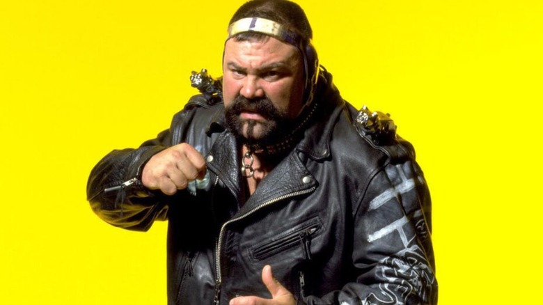 Rick Steiner poses in front of a bright yellow background for a backstage photoshoot in WCW.