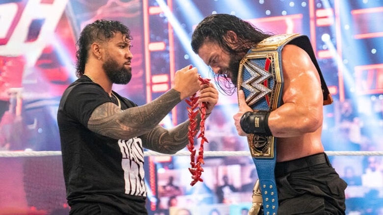 Jey Uso presents Roman Reigns with the ula fala