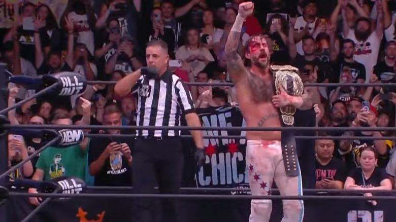 CM Punk celebrating his title win
