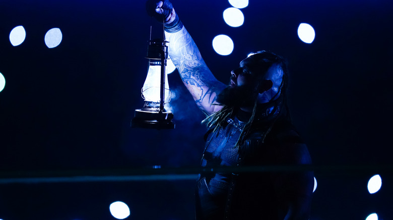 Bray Wyatt holding up lantern