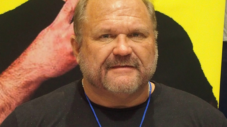 Arn Anderson posing with his book