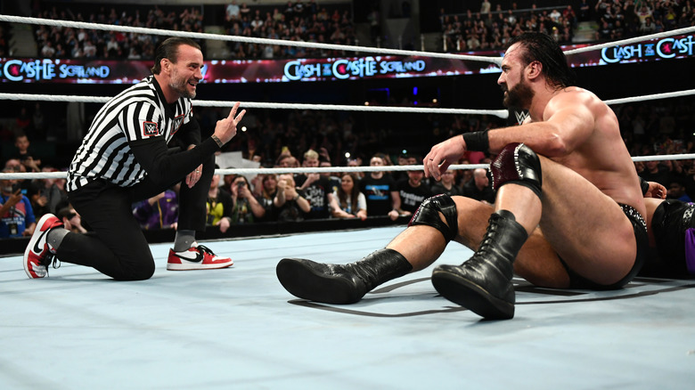 CM Punk showing two fingers to Drew McIntyre