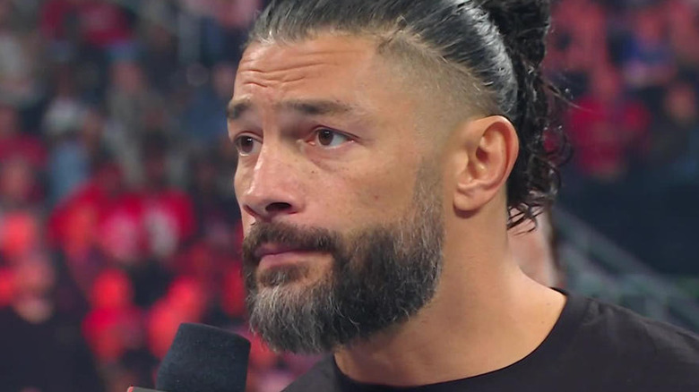 Roman Reigns talking into a microphone