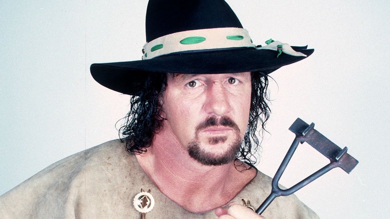 Terry Funk holding a branding iron