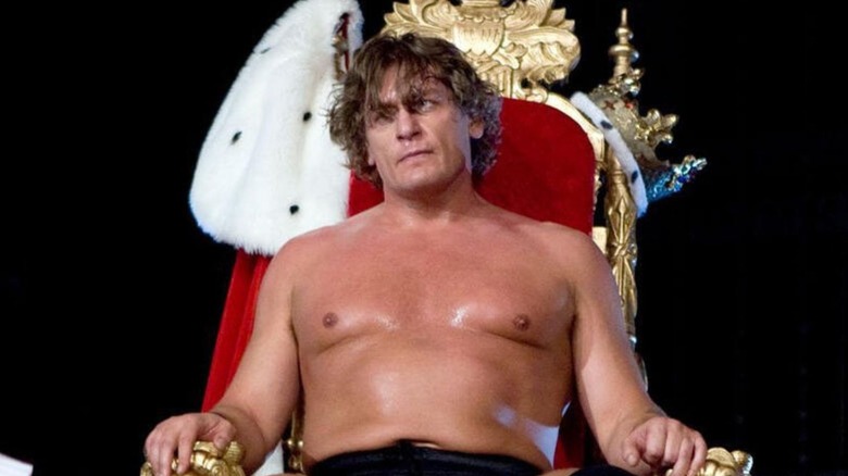 Then-King of the Ring winner William Regal sits on a throne being walked down to the ring before a match on WWE programming.