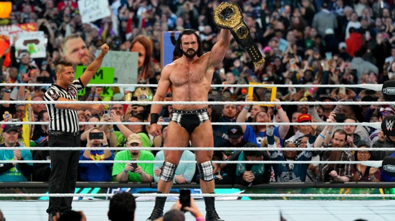 Drew McIntyre holds up the World Heavyweight Championship after winning it from Seth Rollins at WrestleMania 40.