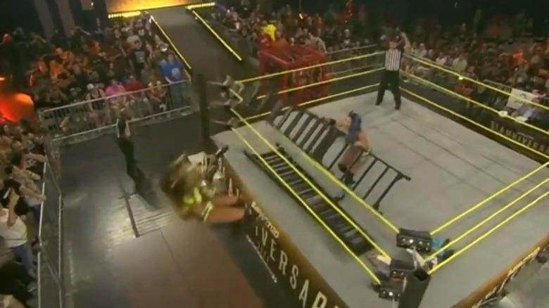 Chelsea Green and Deonna Purrazzo falling toward two tables