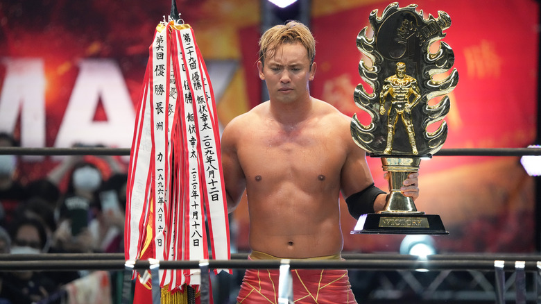 Okada posing with G1 trophy