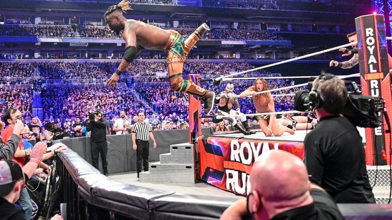 Kofi Kingston flying from the ring