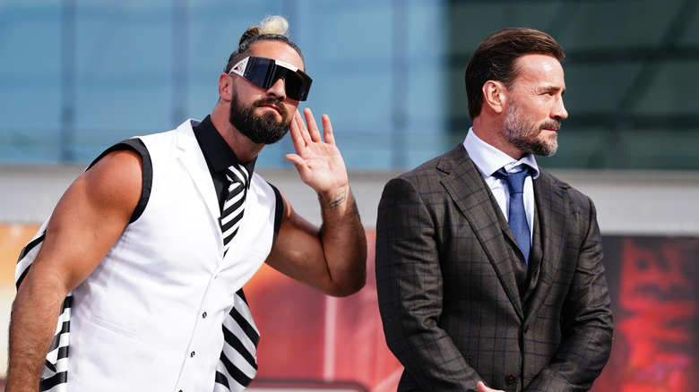 Seth Rollins and CM Punk listen to the crowd during the WWE SummerSlam Kickoff at Rocket Mortgage FieldHouse on August 2, 2024 in Cleveland, Ohio.