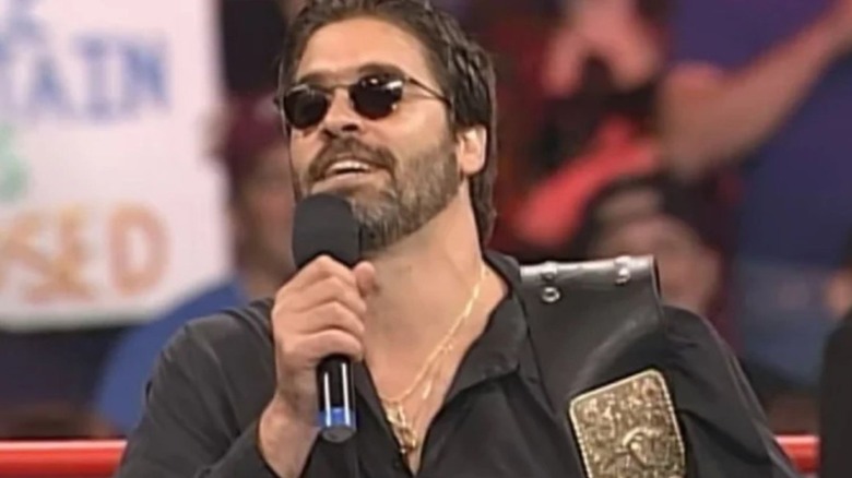 Vince Russo cuts a promo in the middle of the ring wearing the championship belt on an episode of WWE programming.