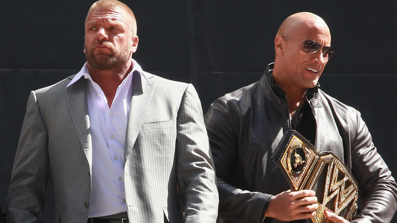 Triple H and The Rock standing next to each other