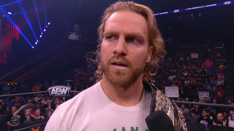 Adam Page holds belt