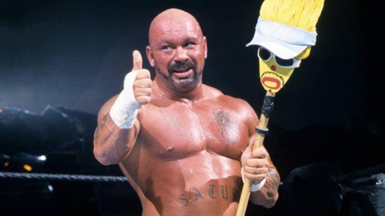 Perry Saturn holding broom, giving thumbs up