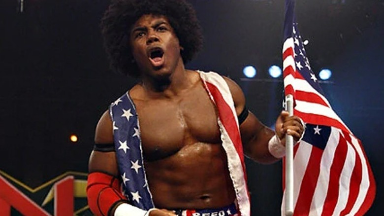 Consequences Creed holding an American flag