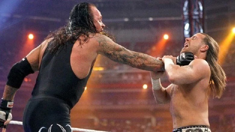 The Undertaker grabbing Shawn Michaels' throat