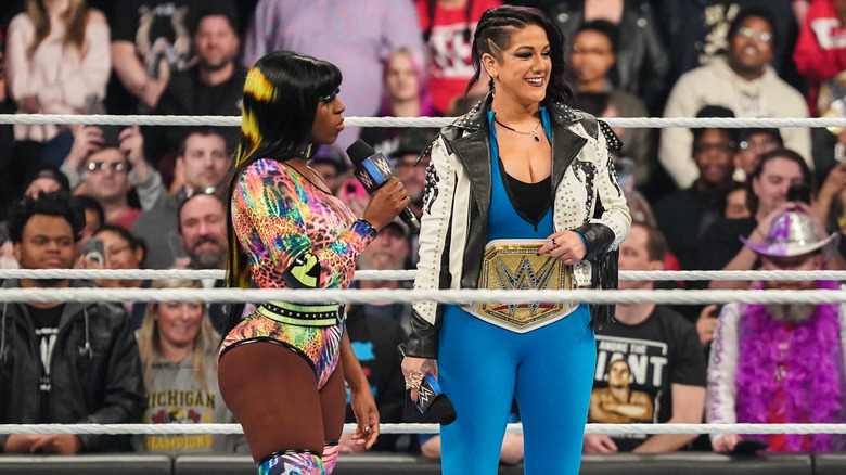 Naomi speaking with Bayley in the ring