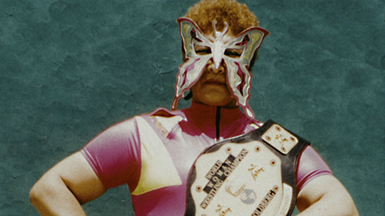 Juana Barraza wears butterfly luchador mask with wrestling championship belt on her shoulder