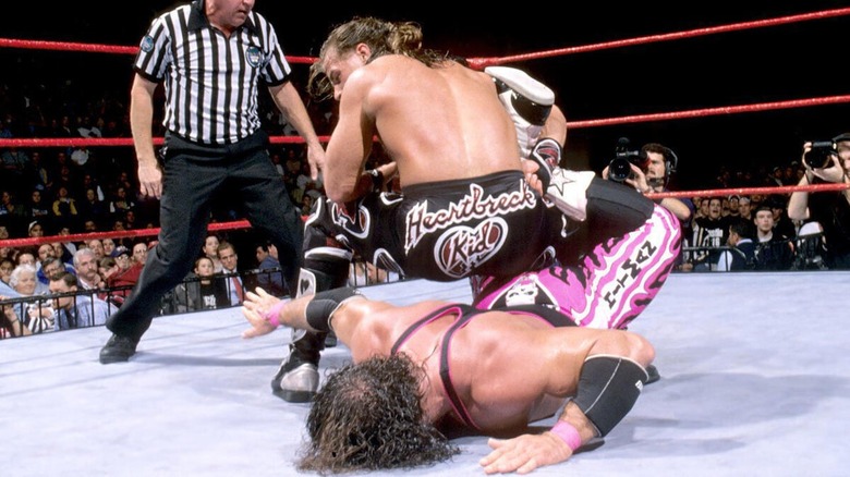 Shawn Michaels applying the Sharpshooter to Bret Hart