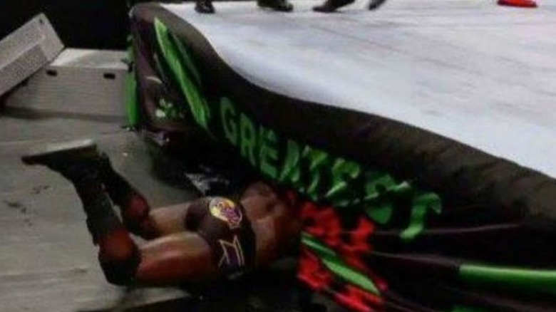 Titus O'Neill sliding under the ring