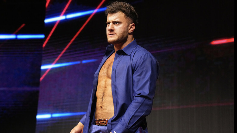 MJF on entrance ramp, wearing unbuttoned blue dress shirt