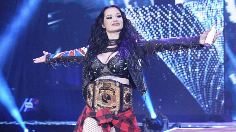 Saraya walking down entrance ramp with championship belt