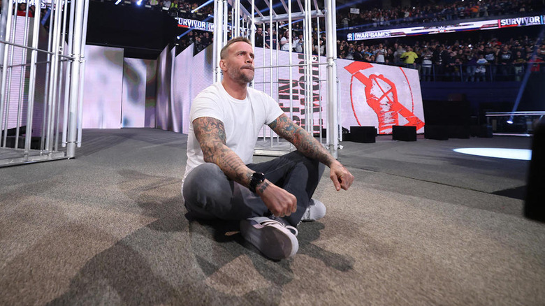 CM Punk sits cross-legged