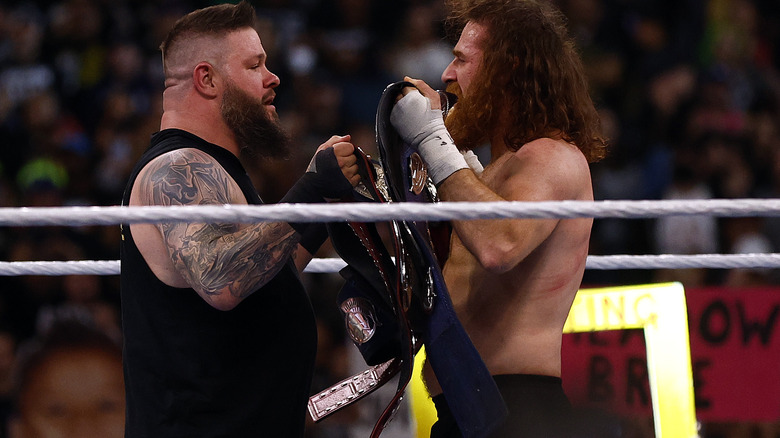 Sami Zayn and Kevin Owens with their title belts