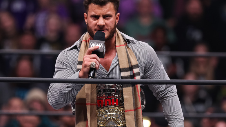 MJF with microphone, wearing title belts