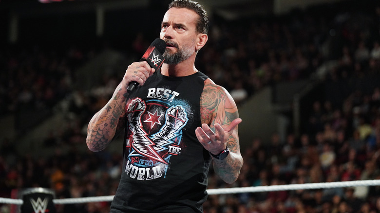 CM Punk holding a microphone on "WWE Raw"